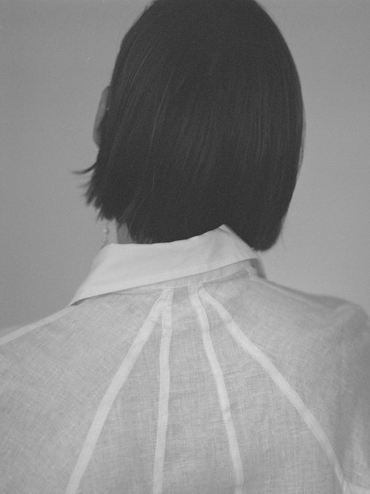 Atelier Magata Ivory white linen shirt with side slit and panel framing back seam
