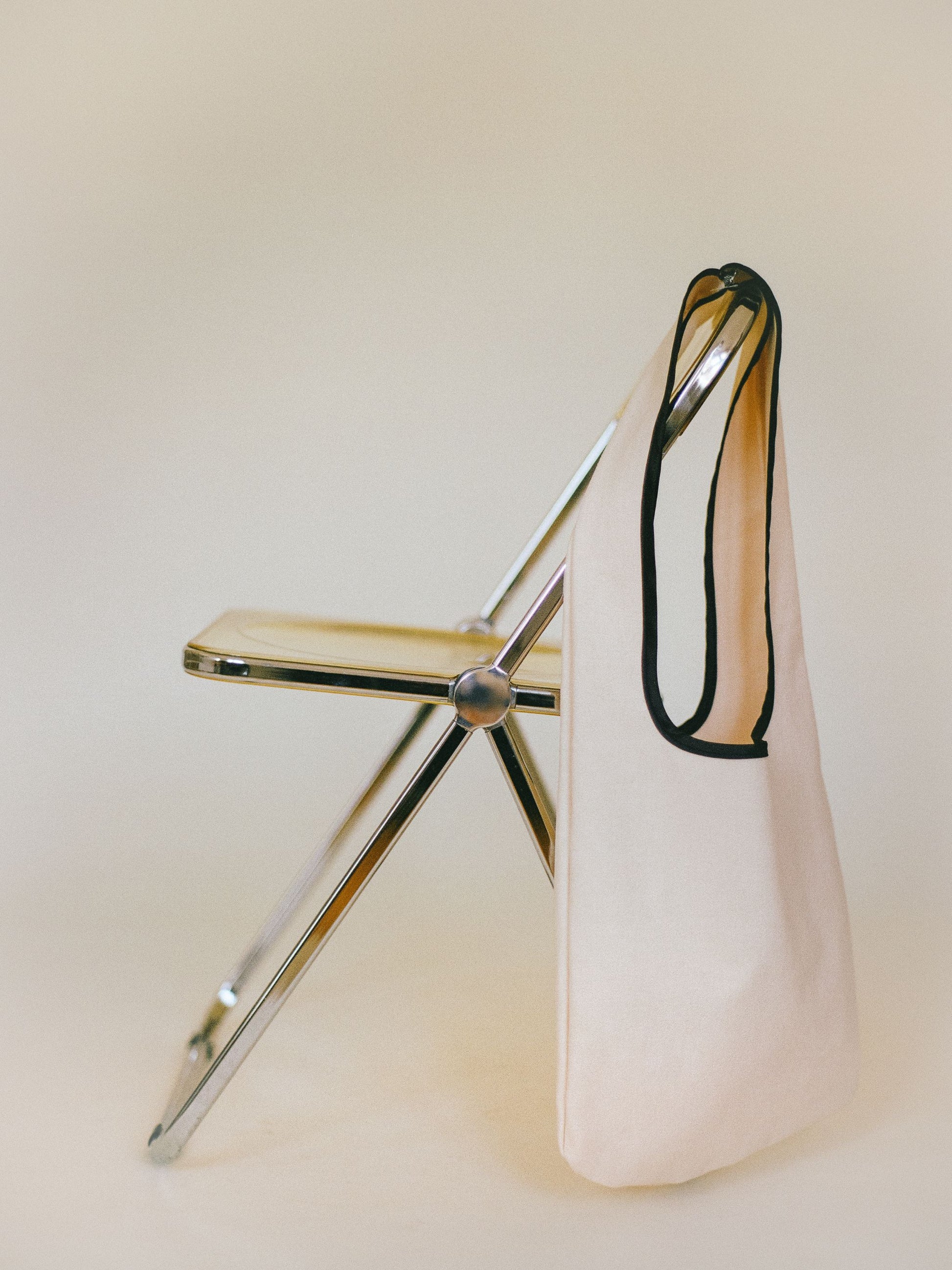 Atelier Magata Soft Utility Tote Bag off white suade velvet on Plia foldable Chair